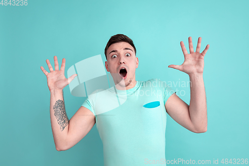 Image of Caucasian young man\'s portrait on blue studio background
