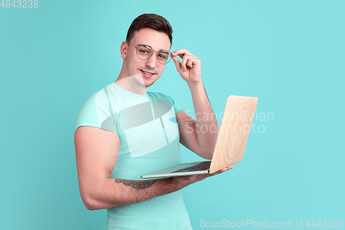 Image of Caucasian young man\'s portrait on blue studio background