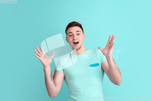 Image of Caucasian young man\'s portrait on blue studio background