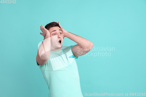 Image of Caucasian young man\'s portrait on blue studio background