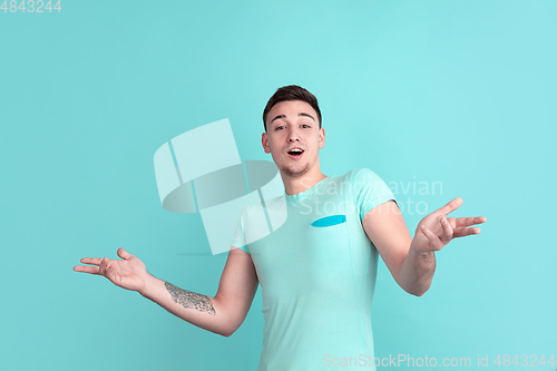 Image of Caucasian young man\'s portrait on blue studio background
