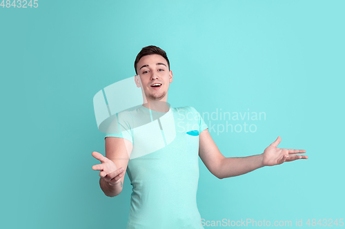 Image of Caucasian young man\'s portrait on blue studio background