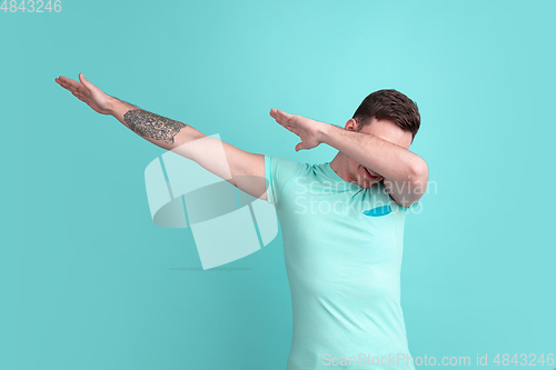 Image of Caucasian young man\'s portrait on blue studio background