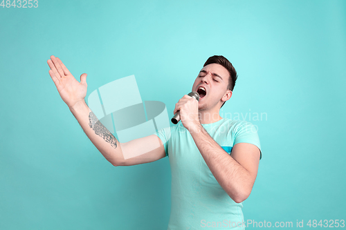 Image of Caucasian young man\'s portrait on blue studio background