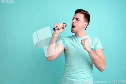 Image of Caucasian young man\'s portrait on blue studio background