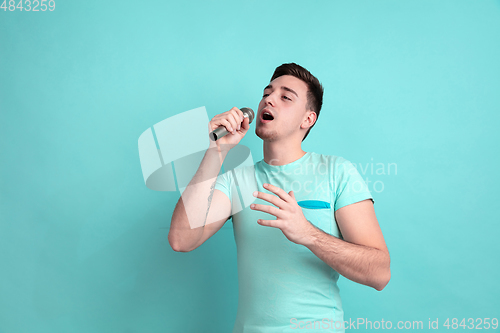 Image of Caucasian young man\'s portrait on blue studio background