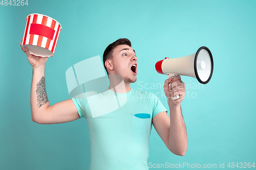 Image of Caucasian young man\'s portrait on blue studio background