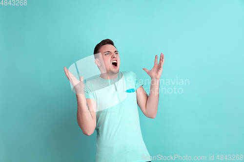 Image of Caucasian young man\'s portrait on blue studio background