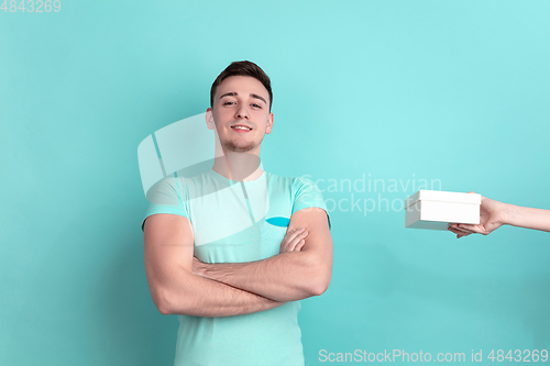 Image of Caucasian young man\'s portrait on blue studio background