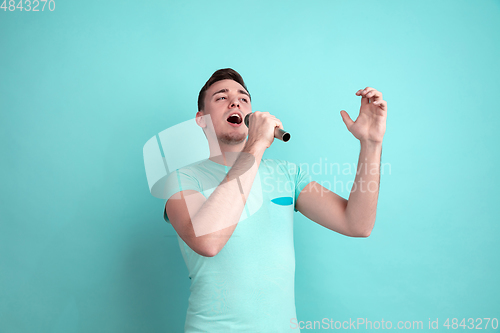 Image of Caucasian young man\'s portrait on blue studio background