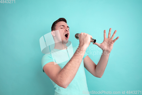 Image of Caucasian young man\'s portrait on blue studio background