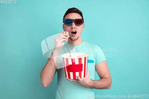 Image of Caucasian young man\'s portrait on blue studio background