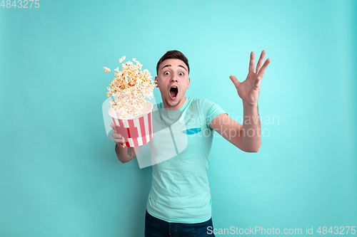 Image of Caucasian young man\'s portrait on blue studio background