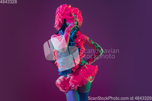 Image of Attractive hawaiian brunette model on purple studio background in neon light