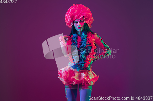 Image of Attractive hawaiian brunette model on purple studio background in neon light