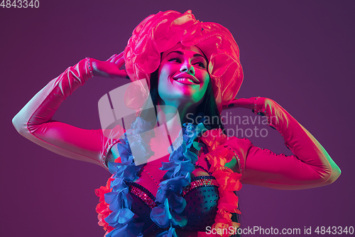 Image of Attractive hawaiian brunette model on purple studio background in neon light