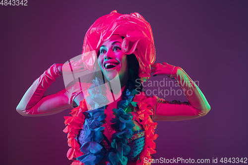 Image of Attractive hawaiian brunette model on purple studio background in neon light