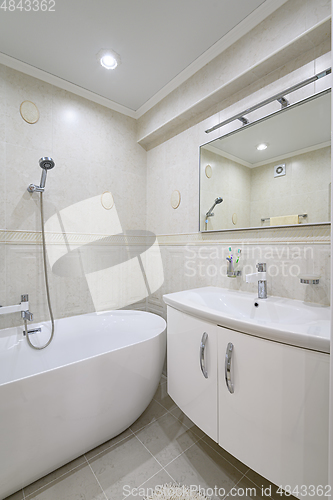 Image of Compact white cozy bathroom with bathub