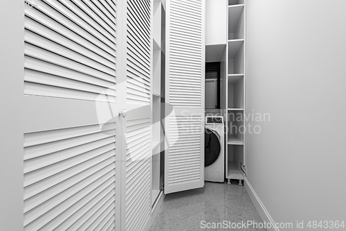 Image of White laundry space inside wardobe room in new apartment