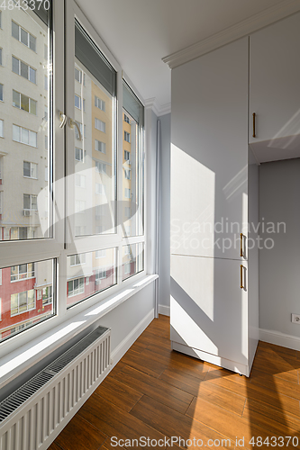 Image of Empty heated penthouse living room with floor to ceiling windows