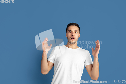 Image of Caucasian young man\'s portrait on blue studio background