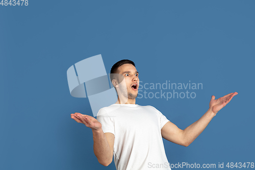 Image of Caucasian young man\'s portrait on blue studio background