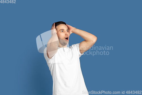 Image of Caucasian young man\'s portrait on blue studio background