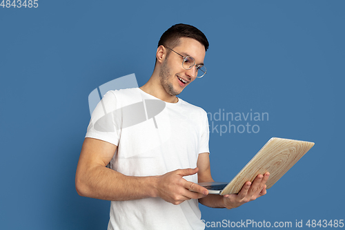 Image of Caucasian young man\'s portrait on blue studio background