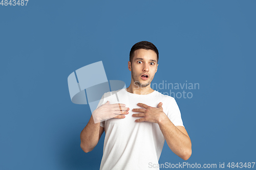 Image of Caucasian young man\'s portrait on blue studio background