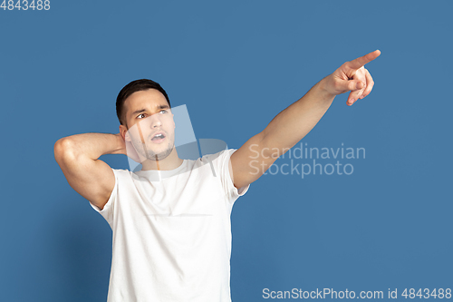 Image of Caucasian young man\'s portrait on blue studio background