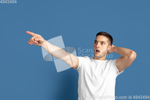 Image of Caucasian young man\'s portrait on blue studio background