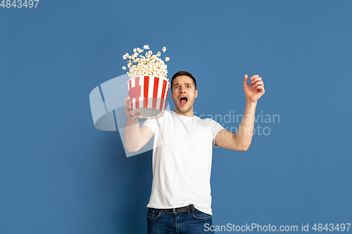 Image of Caucasian young man\'s portrait on blue studio background