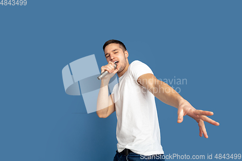 Image of Caucasian young man\'s portrait on blue studio background