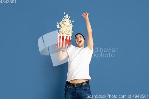 Image of Caucasian young man\'s portrait on blue studio background