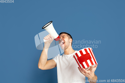 Image of Caucasian young man\'s portrait on blue studio background