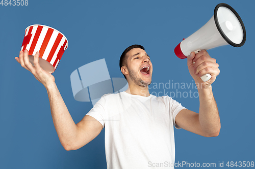 Image of Caucasian young man\'s portrait on blue studio background