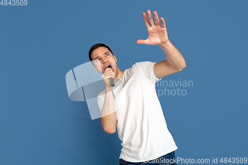 Image of Caucasian young man\'s portrait on blue studio background