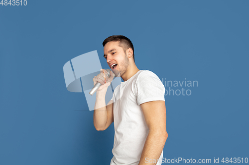 Image of Caucasian young man\'s portrait on blue studio background