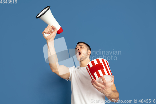 Image of Caucasian young man\'s portrait on blue studio background