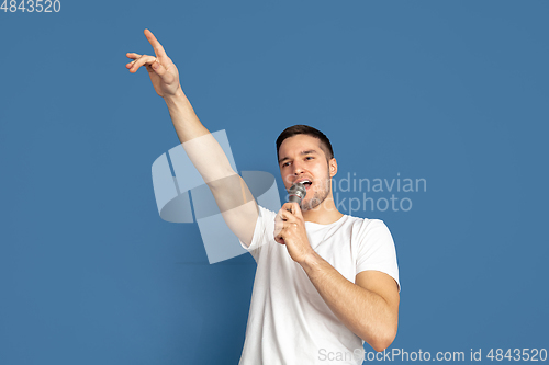 Image of Caucasian young man\'s portrait on blue studio background