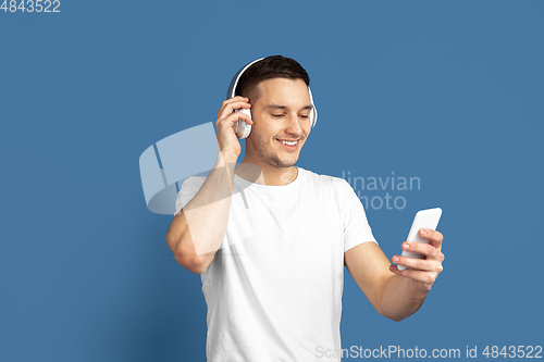 Image of Caucasian young man\'s portrait on blue studio background