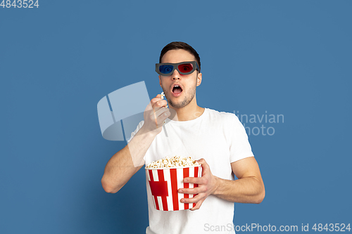 Image of Caucasian young man\'s portrait on blue studio background