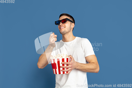 Image of Caucasian young man\'s portrait on blue studio background