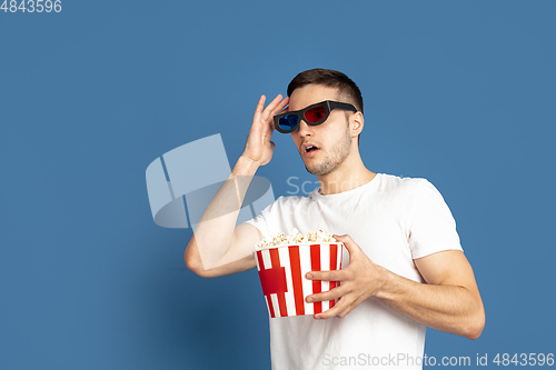 Image of Caucasian young man\'s portrait on blue studio background