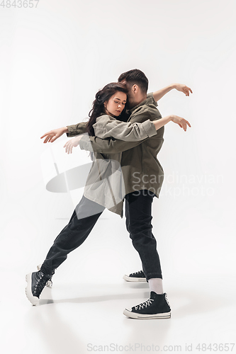 Image of Trendy fashionable couple isolated on white studio background