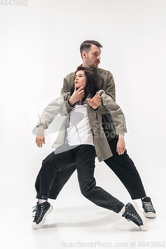 Image of Trendy fashionable couple isolated on white studio background