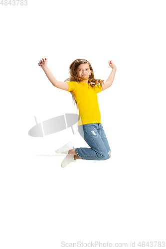 Image of Happy kid, girl isolated on white studio background. Looks happy, cheerful, sincere. Copyspace. Childhood, education, emotions concept