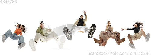 Image of Young stylish people in modern street style outfit isolated on white background, view from the bottom. Fashionable models, musicians, rappers performing.