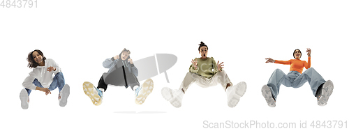 Image of Young stylish people in modern street style outfit isolated on white background, view from the bottom. Fashionable models, musicians, rappers performing.