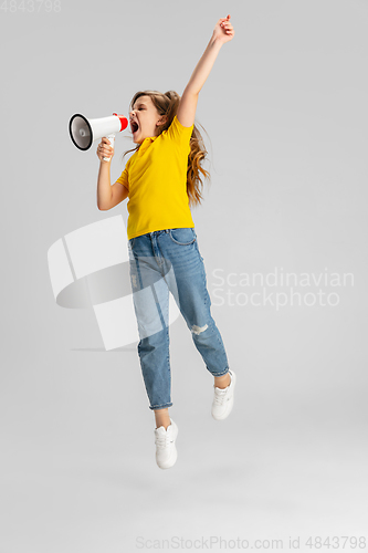 Image of Happy kid, girl isolated on white studio background. Looks happy, cheerful, sincere. Copyspace. Childhood, education, emotions concept